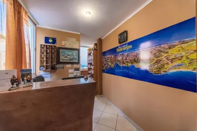 a lobby of a hotel with a reception desk at 