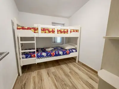 a bedroom with two bunk beds in a room at Villa Masha in Rijeka Reževići