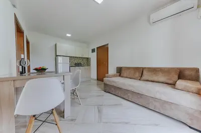 a living room with a couch and a table at Sea Garden Apartments in Dobra Voda