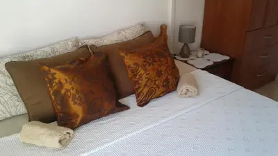 a bed with orange and white pillows on it at Apartments Villa Andjela in Budva