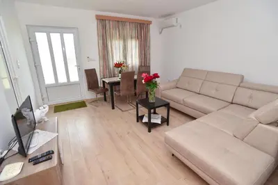 a living room with a couch and a table at Apartmani Mihovic - JAZ in Budva