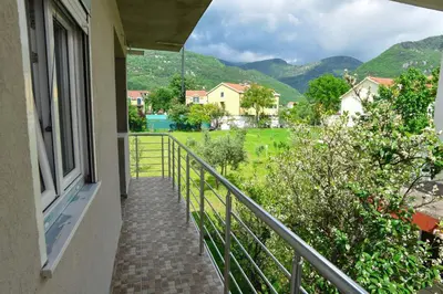 a balcony of a house with a view of the mountains at Apartmani Mihovic - JAZ in Budva