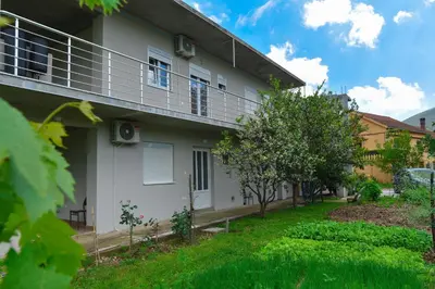 a house with a balcony on the side of it at Apartmani Mihovic - JAZ in Budva
