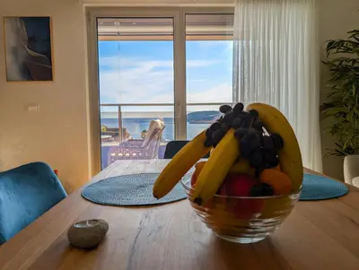 a bowl of fruit sitting on top of a wooden table at Lux Apartments Harmonia in Budva