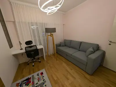 a living room with a couch and a chair at Lux Apartments Harmonia in Budva