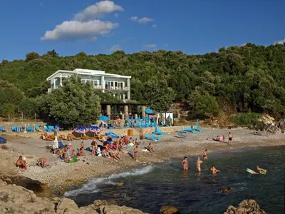 a group of people on a beach near the water at Arabela Apartments in Utjeha