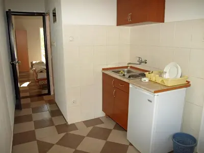 a kitchen with a sink and a counter top at Arabela Apartments in Utjeha