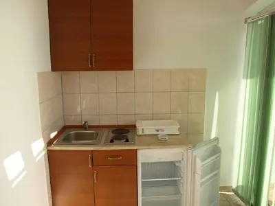 a small kitchen with a sink and a stove at Arabela Apartments in Utjeha