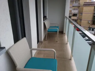 a corridor with two chairs in a building at Apolonia Lux Apartment in Budva