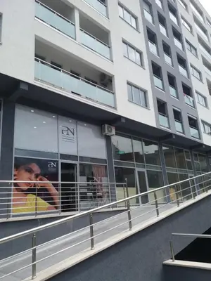 a man is looking out the window of a building at Apolonia Lux Apartment in Budva