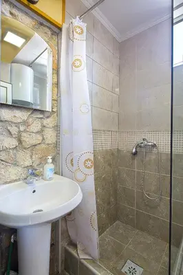 a bathroom with a sink and a shower at Apartman Kunjić in Krimovice