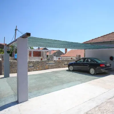 a black car parked in a parking lot at Apartman Kunjić in Krimovice