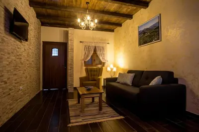 a living room with a couch and a table at Eco Villas Merak in Virpazar