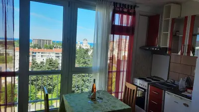 a kitchen with a table in front of a window at Sea-view apartment in Bar