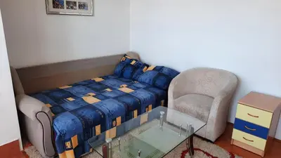 a bedroom with a bed and a chair and a glass table at Sea-view apartment in Bar