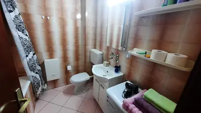 a bathroom with a white toilet and a sink at Sea-view apartment in Bar