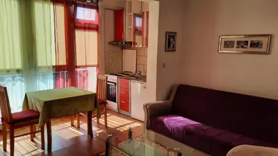 a living room with a couch and a table at Sea-view apartment in Bar