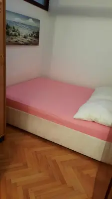 a bed with a pink mattress in a room at Sea-view apartment in Bar