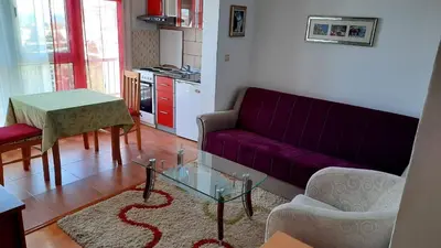 a living room with a purple couch and a table at Sea-view apartment in Bar
