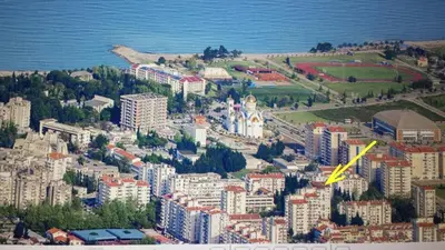 an aerial view of a city with a yellow arrow at Sea-view apartment in Bar