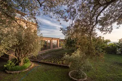 a glass house with a garden in front of it at Apart & Spa Beganovic in Dobra Voda