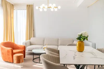 a living room with a couch and a table and chairs at Apart & Spa Beganovic in Dobra Voda