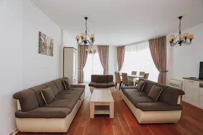 a living room with two couches and a table at Apartment Mimosa of Tre Canne in Budva