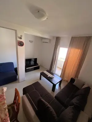 a living room with a couch and a table at Rajovic Apartments in Tivat