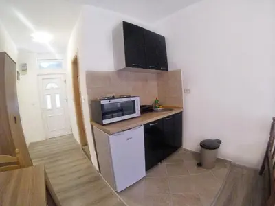 a small kitchen with a sink and a microwave at Rajovic Apartments in Tivat