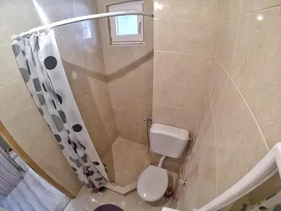 a bathroom with a shower with a toilet at Rajovic Apartments in Tivat