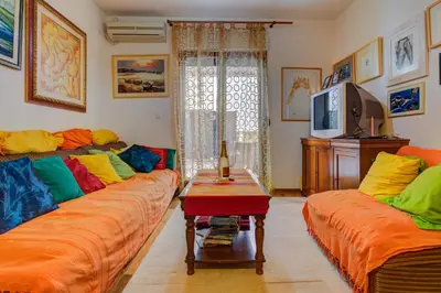 a living room with two couches and a tv at Allegro Apartment Sekulic in Petrovac na Moru