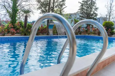 a swimming pool with a water fountain at Miami apartments in Ulcinj
