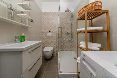 a bathroom with a shower and a sink and a toilet at Old Town Clock Tower Apartment in Kotor