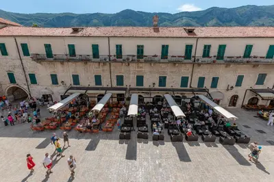 a group of people standing in front of a building at Old Town Clock Tower Apartment in Kotor