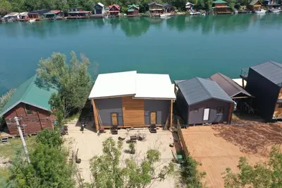 an aerial view of a group of huts on the water at Meris in Ulcinj