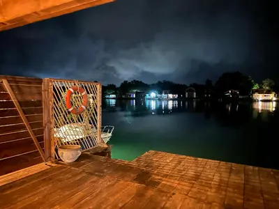 a wicker chair sitting on a dock at night at Meris in Ulcinj