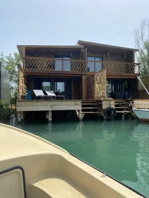a house on a dock in the water at Meris in Ulcinj