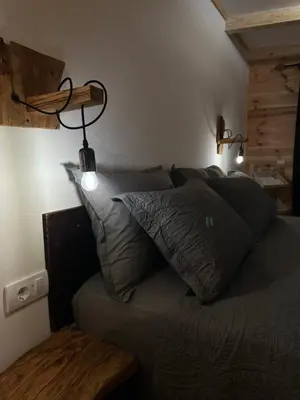 a bed with pillows on it in a room at Meris in Ulcinj