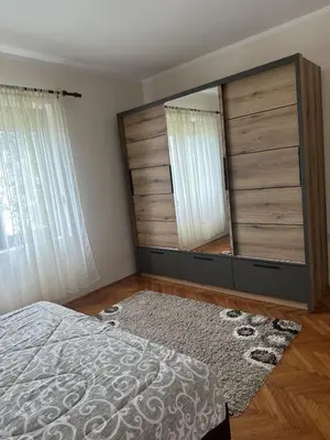 a bedroom with a large mirror and a bed at Apartments Radulović in Ulcinj