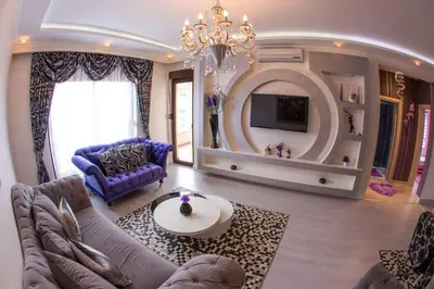 a living room with a purple couch and a chandelier at Bečiči - Andrea apartman in Becici