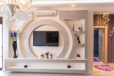 a living room with a tv and a large mirror at Bečiči - Andrea apartman in Becici