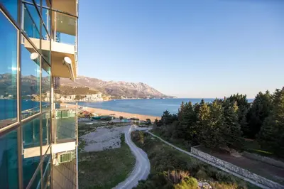 a view of the beach from the balcony of a building at Bečiči -Big apartments in Becici