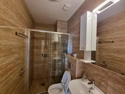 a bathroom with a shower and a toilet and a sink at Bečiči -Big apartments in Becici