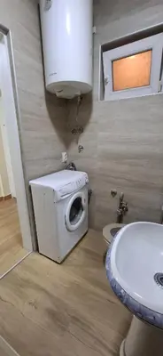 a bathroom with a washing machine and a sink at Sunčani apartman 2-Vila Amfora in Budva