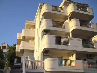 a white building with balconies on the side of it at Villa Beba in Dobra Voda