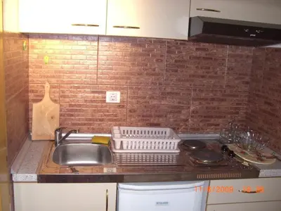 a kitchen counter top with a sink and a counter top at Villa Beba in Dobra Voda