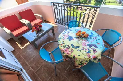 a balcony with a table and chairs on a balcony at Villa Beba in Dobra Voda