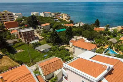 an aerial view of a city with buildings and the ocean at Villa Beba in Dobra Voda