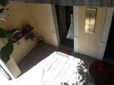an entrance to a building with potted plants and a door at Apartman Centar in Cetinje