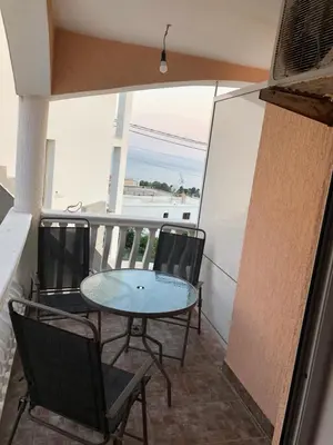a patio with a table and chairs on a balcony at Apartments Harmony in Ulcinj